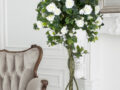 Beautiful Provance Living Room With vintage brown Sofa Near fireplace With Flowers And Candles.